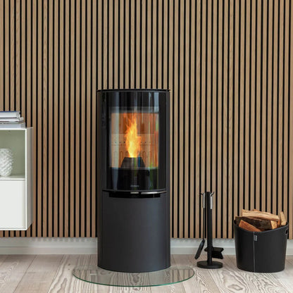 Aduro H4 Lux hybridkamin med blank helglaslucka placerad framför en stilren ribbvägg i trä